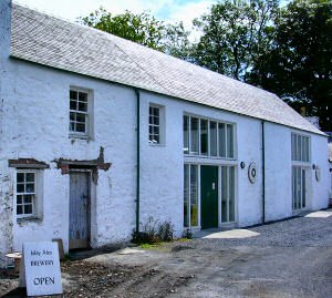 Picture of a whitewashed building housing a distillery