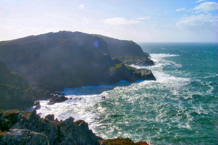 Picture of high cliffs with waves breaking under them