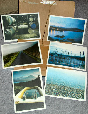 Picture of 6 postcards spread out on an envelope/box