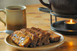 Picture of slices of Islay Loaf on a plate with some tea in the background