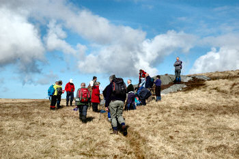 Picture of a group of walkers taking a break on a hill