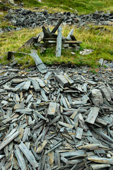 Picture of slate pieces in a disused quarry, some of it in a pile