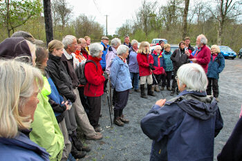 Picture of a group of walkers listening to a walk leader speaking