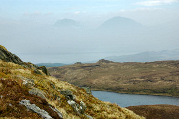 Picture of two hill tops appearing out of low mist