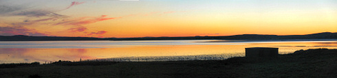 Sunset over Loch Indaal. Much better in bigger Picture of a panoramic view of a sunset