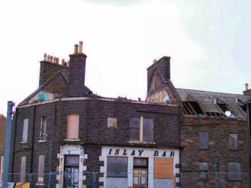 Picture of the Islay Bar with a construction site fence