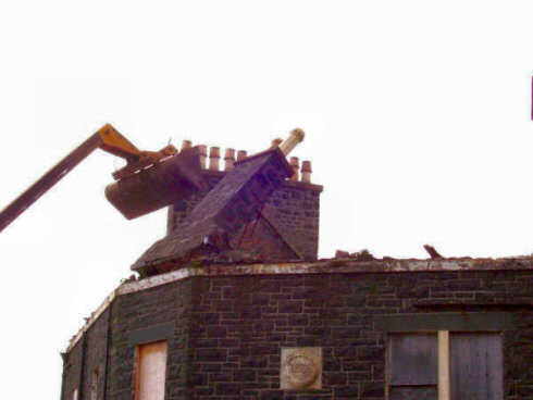 There goes the chimney at the corner above the entrance of the Islay Bar Picture of a digger pushing over a chimney