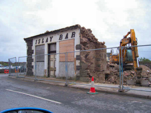 Picture of the last walls of a building to be demolished still remaining, the sign 'Islay Bar' still visible