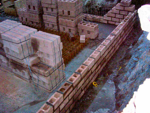 Picture of the foundations with the first rows of bricks for some walls