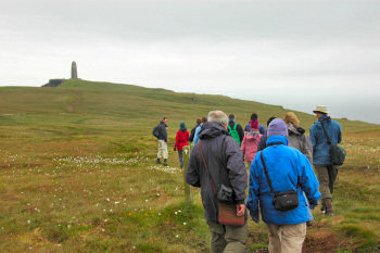 Picture of a group of walkers with a monument in the distance
