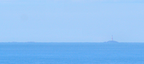 Picture of a lighthouse on some isolated rocks