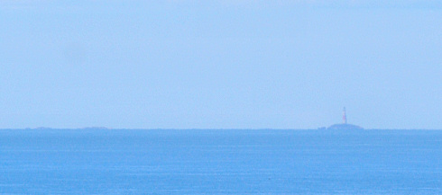 Picture of a lighthouse on some isolated rocks