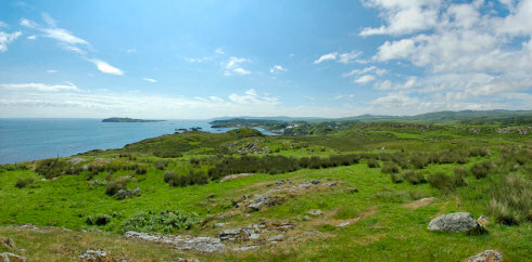 Picture of a wide panoramic view over a shoreline with a bay and a distillery