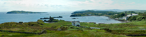 Picture of a panoramic view over a bay with a distillery, an island on the sea next to the bay