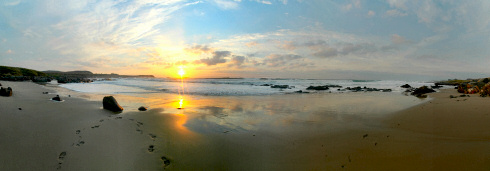 Picture of a panoramic view of a sunset over a sandy bay