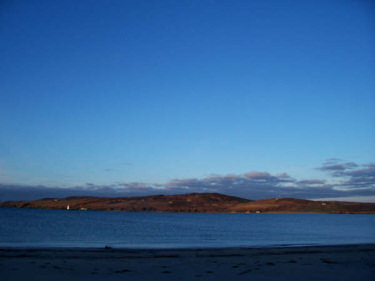 Picture of a wide bay in the early morning sunshine under a bright blue sky