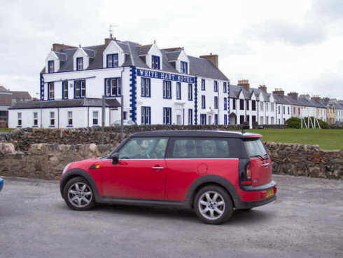 Picture of a red Mini Clubman in front of the White Hart Hotel in Port Ellen, Islay
