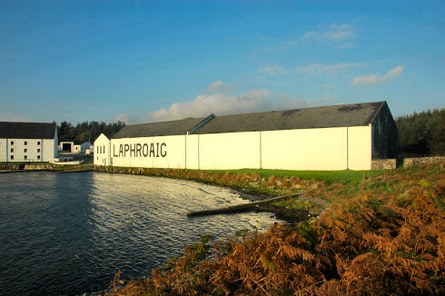 Picture of a huge whitewashed warehouse with the large lettering 'Laphroaig' on the side