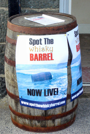 Picture of a barrel with posters promoting the 'Spot the Barrel' competition