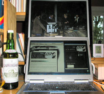 Picture of a laptop and an external monitor set up to watch the Laphroaig Live webcast, the whole panel on screen