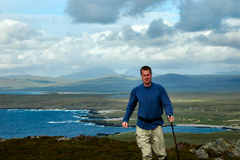 Picture of a man walking in the hills of an island