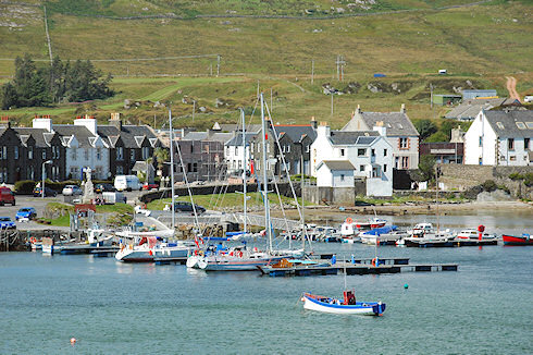 Picture of a view over a small sea loch harbour with a marina and a village