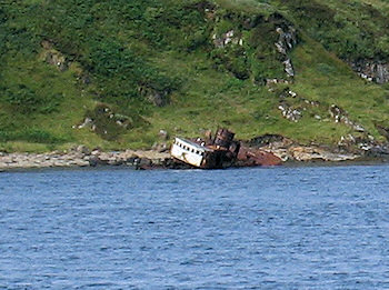 Picture of the wreck of a fishing trawler close to a rocky shore