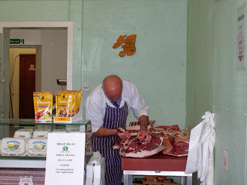 Picture of a butcher de-boning a pig