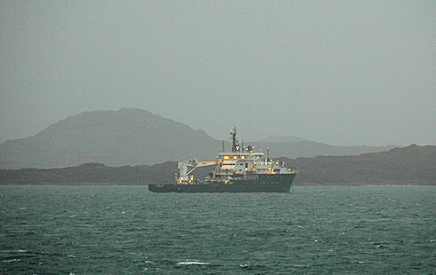 Picture of a navaids tender sheltering behind an island