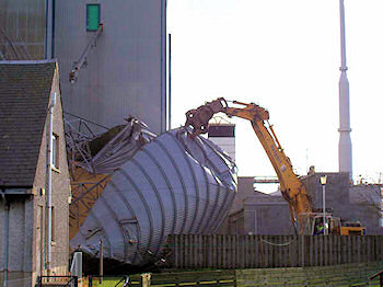 Picture of a digger working at a collapsed grain silo