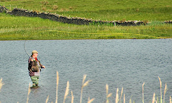 Picture of an angler flyfishing on a loch