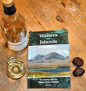 Picture of a book 'Writers on Islands' with Islay whisky and chocolate around it