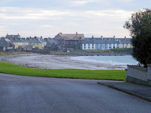 Looking from the maltings over to the building site of the Islay Hotel Picture of a view over a coastal village, an under construction hotel in the centre