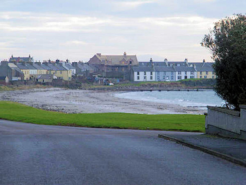 Picture of a view over a coastal village, an under construction hotel in the centre