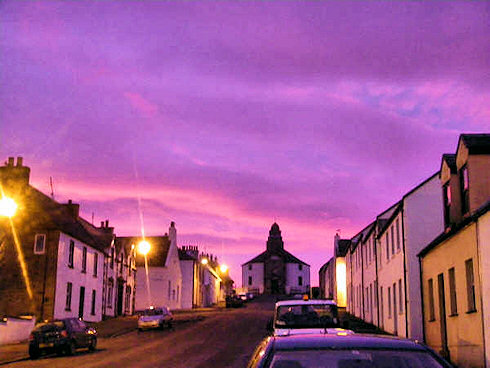 Picture of the main road in a small village leading to a round church