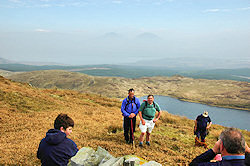 Picture of walkers on the summit of a hill, very hazy views