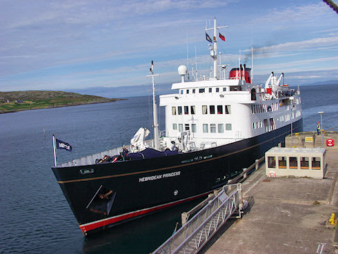 Picture of a small cruise ship leaving from a pier