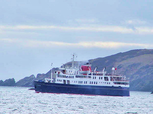 Picture of a small cruise ship leaving a bay