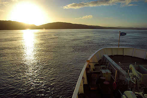 Picture of a sunset over an island, seen from a ferry