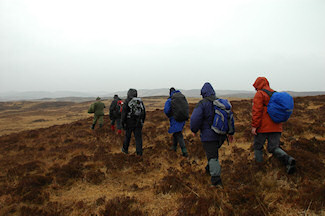 Picture of a group of walkers on a rainy moorland stretch