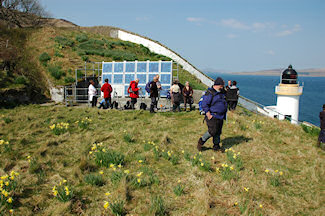 Picture of a group of walkers at a remote lighthouse