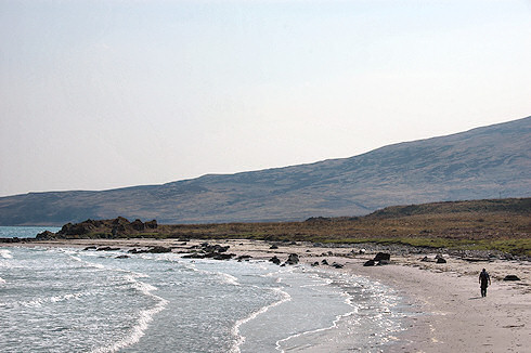 Picture of a walker on a sandy beach, very nice warm sunlight