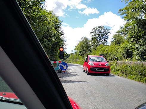 Picture of a car passing temporary traffic lights