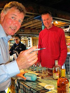Picture of Jim McEwan of Bruichladdich distillery about to sign a bottle of whisky