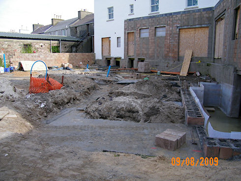 Picture of the foundations for an extension at the back of an under construction hotel