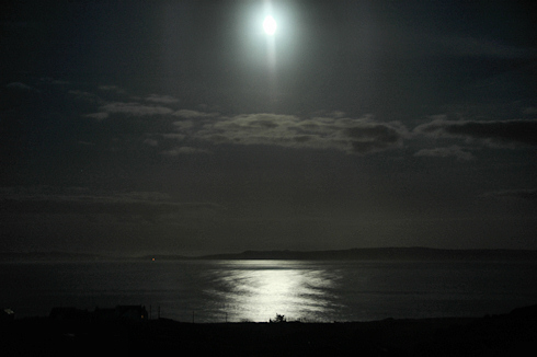 Picture of the moon over a sea loch, Loch Indaal on Islay