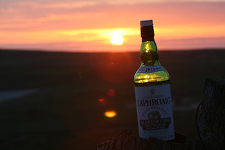 Picture of a bottle of Laphroaig Quarter Cask against a sunset