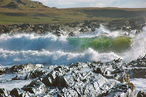 Picture of waves breaking on a rocky shore at the end of a beach