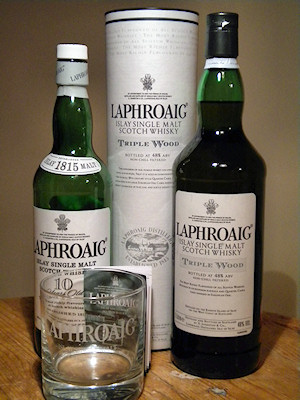 Picture of a bottle of Laphroaig Triple Wood Islay single malt whisky. Also a bottle of the normal 10yo for size comparison