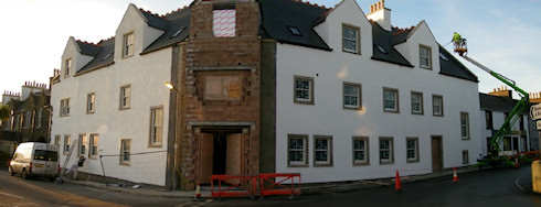 Picture of an under construction hotel, both wings painted, only the main portal awaiting completion